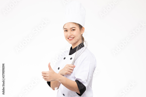 Beautiful Asian chef woman smile and holding Stainless balloon whisk isolated on white background,Happiness and Cheerful Professional chef Concept