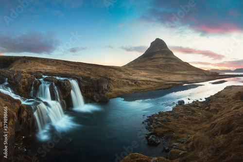 Scenic image of Iceland. Great view on famouse Mount Kirkjufell With Kirkjufell waterfall during sunset. Wonderful Nature landscape. Popular Travel destinations. Picture of wild area. 