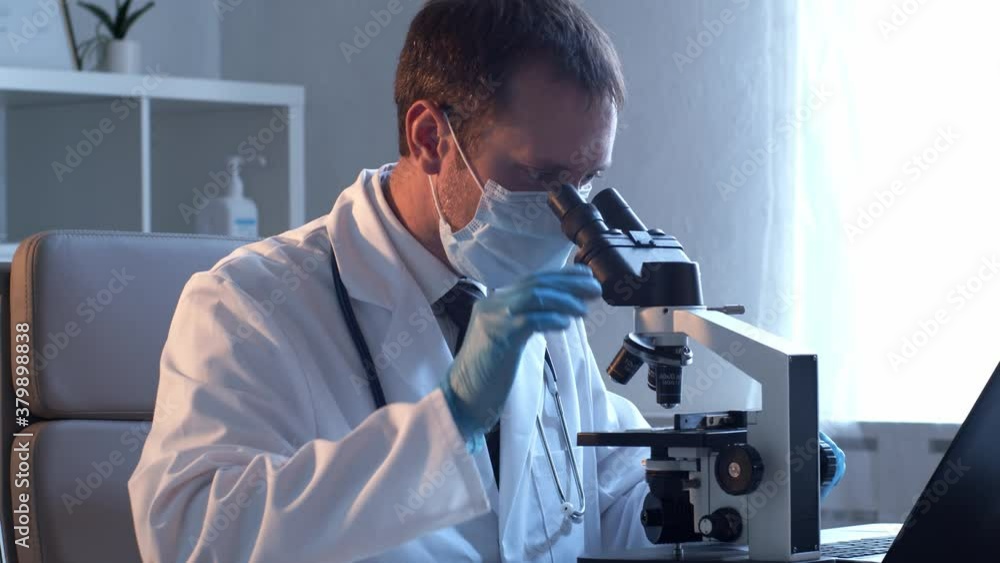 Professional medical doctor working in laboratory using microscope. Professional medical doctor working in laboratory using microscope.
