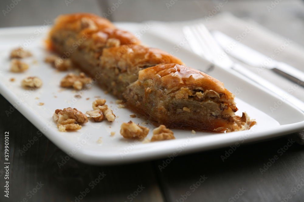Baklava with walnut on a white plate close up Baklava with walnut on a white plate close up