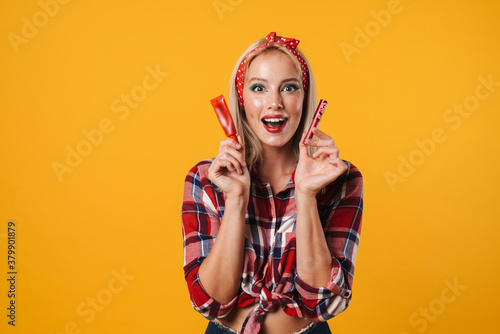 Image of excited pinup girl posing with lip gloss and eyes cream