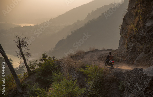 Man driving a motorbike on the mountain road photo