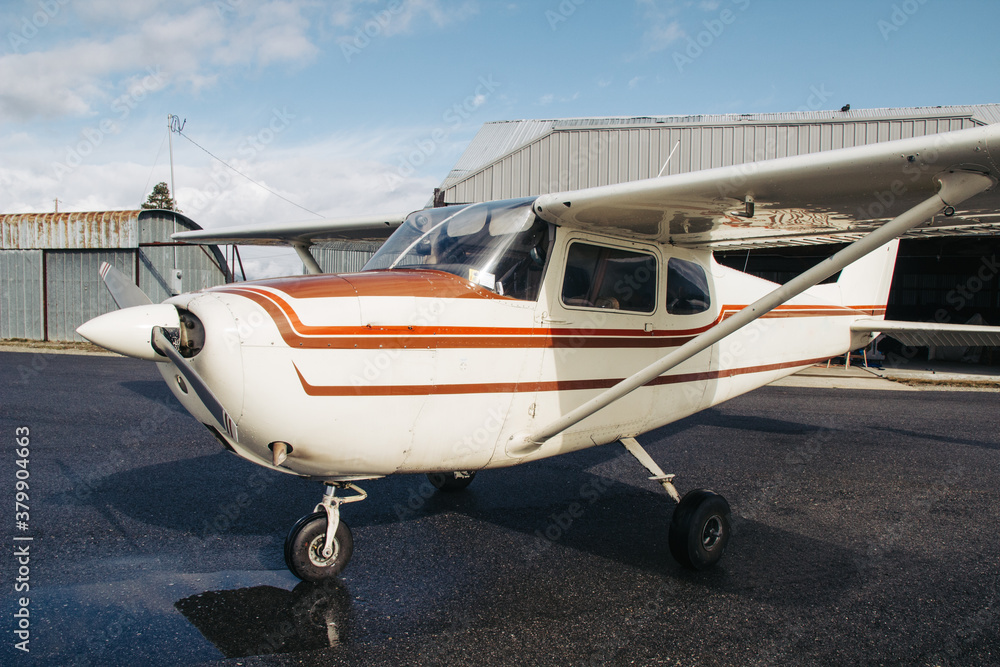 Small four passenger aircraft on tarmac at small rural airport. Small four passenger aircraft on tarmac at small rural airport.