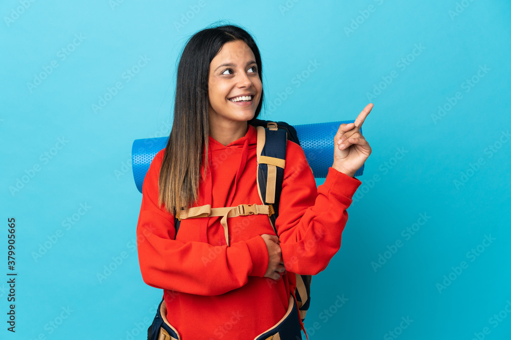 Young mountaineer woman with backpack pointing up a great idea Young mountaineer woman with backpack pointing up a great idea