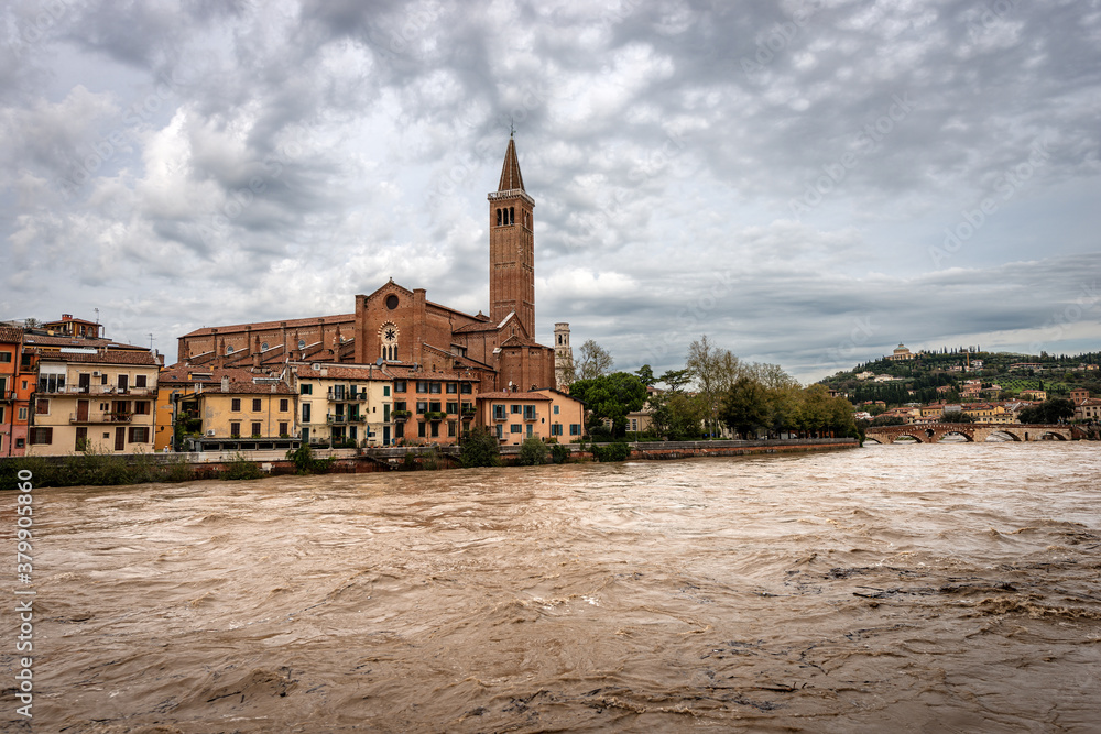 River Adige in flood in Verona downtown after several violent storms. Church of Santa Anastasia and the Ponte Pietra (Stone bridge), I century B.C. UNESCO world heritage site, Veneto, Italy, Europe River Adige in flood in Verona downtown after several violent storms. Church of Santa Anastasia and the Ponte Pietra (Stone bridge), I century B.C. UNESCO world heritage site, Veneto, Italy, Europe