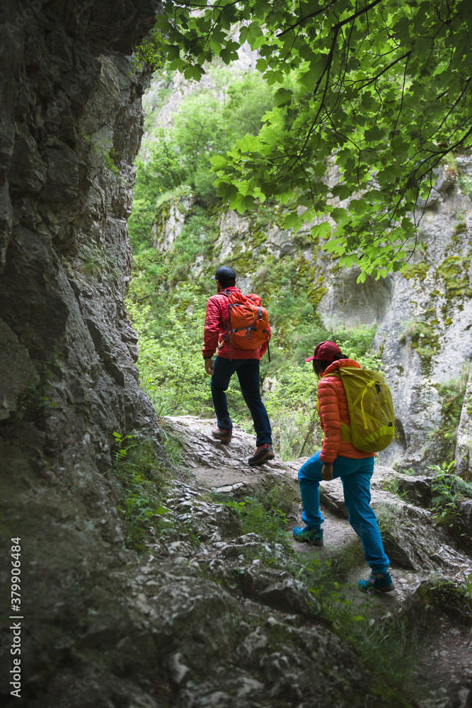 Hikers following a mountain trail on a spring day