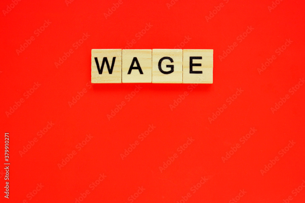 Word wage. Wooden blocks with lettering on top of red background. Top view of wooden blocks with letters on red surface Word wage. Wooden blocks with lettering on top of red background. Top view of wooden blocks with letters on red surface
