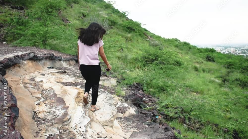 Young Indian active and fit female walking on the mountain Young Indian active and fit female walking on the mountain