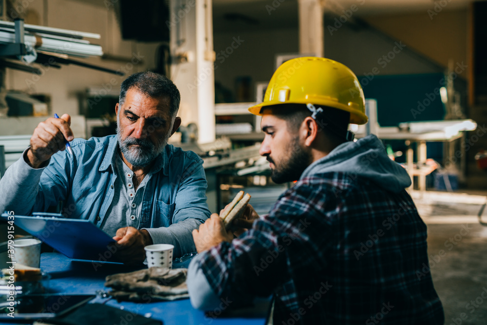 workers sitting at the table and having lunch break workers sitting at the table and having lunch break