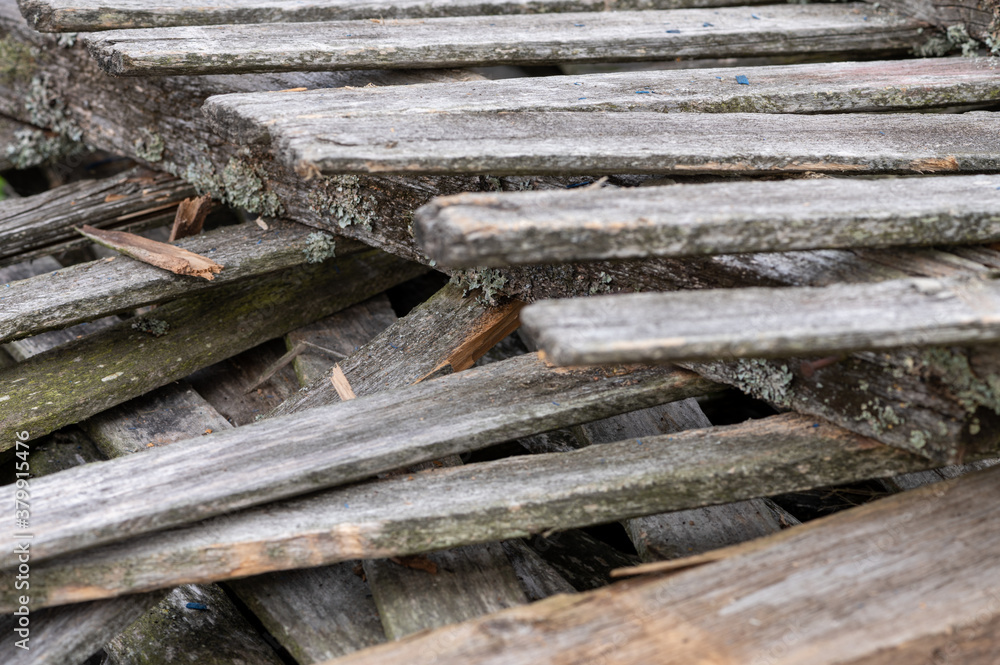 A pile of old boards suitable for the furnace, close-up, selective focus. A pile of old boards suitable for the furnace, close-up, selective focus.