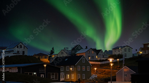 northern lights enjoyed in front of typical icelandic houses during an autumn holiday in iceland © Stefano