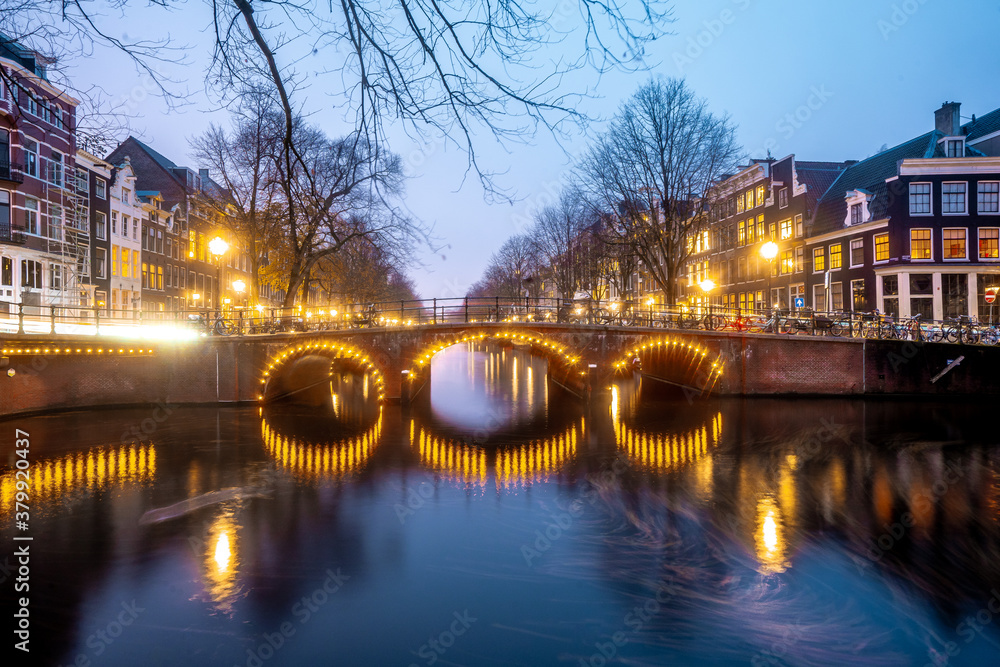 Beautiful bridges in the center of Amsterdam by night during winter , Netherlands