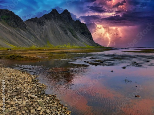 mountains with thunderstorm during a holiday in iceland by a lake