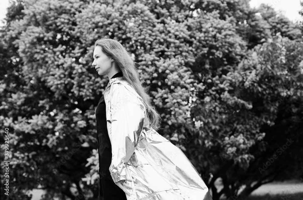 Young woman wearing silver raincoat Young woman wearing silver raincoat