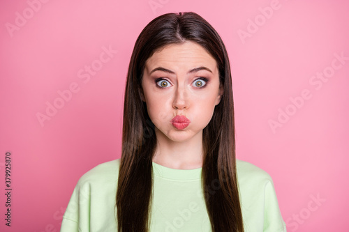 Closeup photo of funky childish pretty lady straight long hairdo hold breathe for bet mouth full of air cute wear casual green sweatshirt pullover isolated pink pastel color background