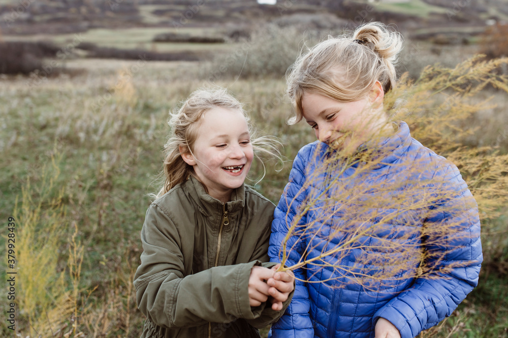 Young sisters playing together outside Young sisters playing together outside