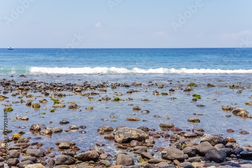 View on Indian ocean coast with pebble and sand beach on Bali, Indonesia