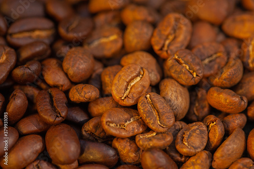 Mixture of different kinds of roasted coffee beans background.