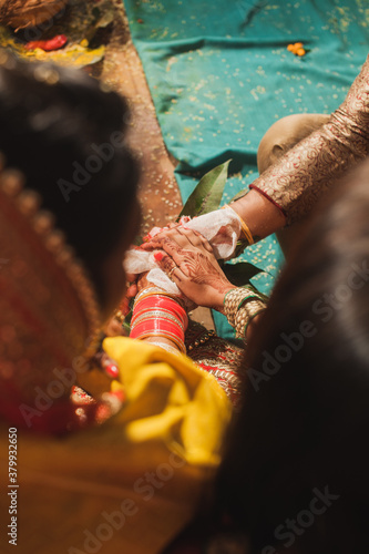 Detail shot of hands at an Indian wedding ceremony photo