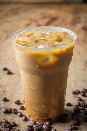 Cold coffee on wooden table.
