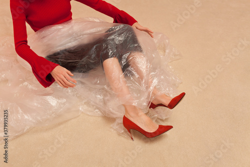 stylish woman playing with plastic sheet photo