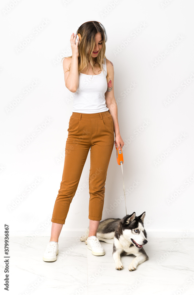 A full length young pretty woman with her dog