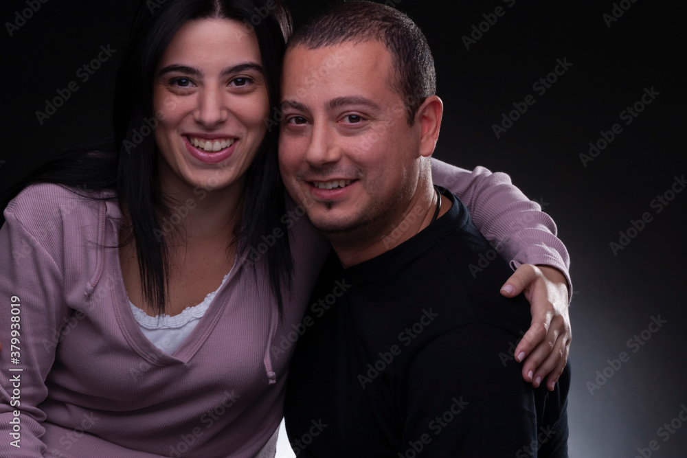 Fototapeta premium beautiful couple embracing, studio light, neutral background
