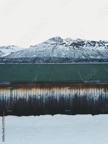 Weathered Wooden Barn in Innerdalen Valley on Cold White Winter Day photo