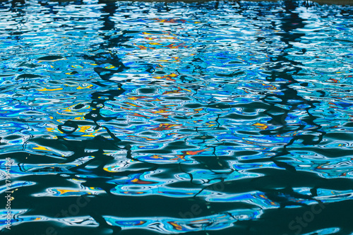 Colorful reflections on the water in the swimming pool