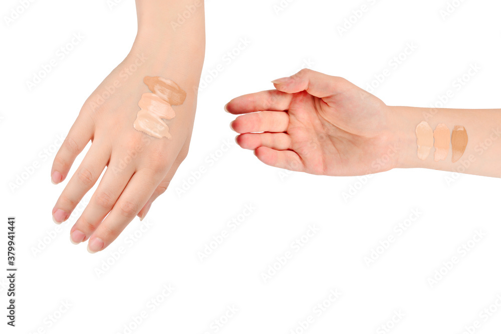 Fair, medium, dark swatches  of foundation on the hand isolated on white.
