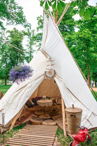 A tent in a summer cafe in a green park. Themed hipster cafe in the city park