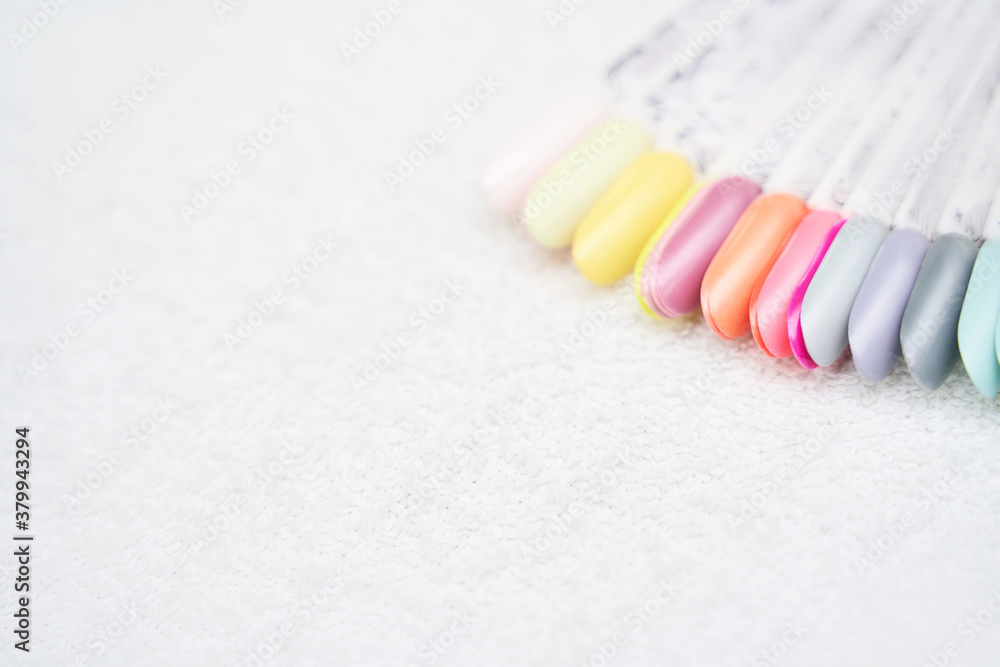 Defferent nail gel wheel sample on white background. Beautiful salon procedure with pink pedicure or manicure. For decoration design. Healthcare. Woman body care. Spa treatment. Nail brush Defferent nail gel wheel sample on white background. Beautiful salon procedure with pink pedicure or manicure. For decoration design. Healthcare. Woman body care. Spa treatment. Nail brush