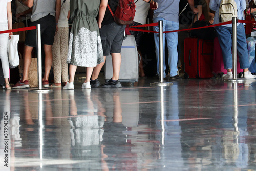 Bild auf Leinwand Queue of people in the airport terminal, selective focus