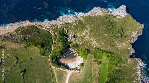 playa de Gulpiyuri, gulpiyuri beach, llanes, Hontoria, Asturia, Spain, beach inside of the rock, high cliffs, cantabrian sea, tourists atraction, ocean, view from above, from air, made by drone