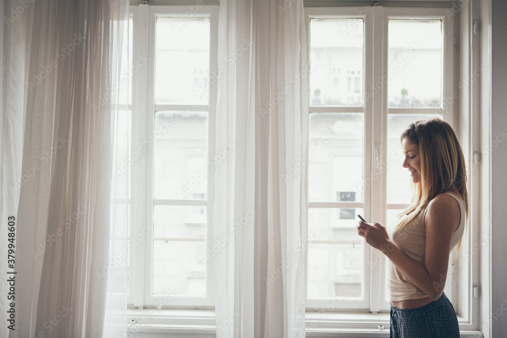 Woman Texting by the Window Woman Texting by the Window