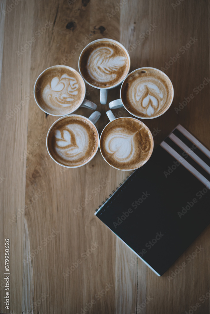 Coffee Cups and a Notebook on the Table Coffee Cups and a Notebook on the Table