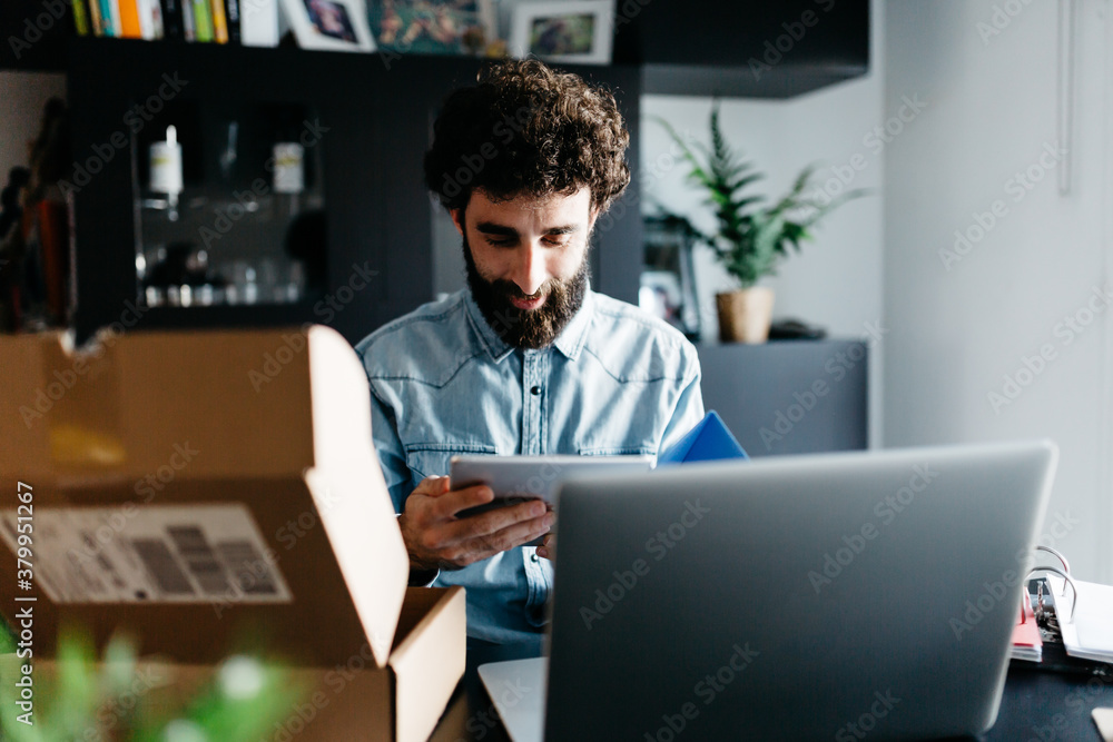Man using his new tablet at desk. Man using his new tablet at desk.