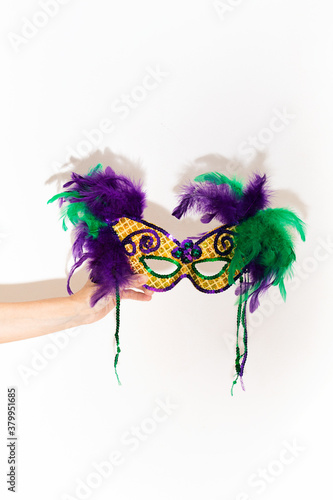 Woman Holds Mardi Gras Mask