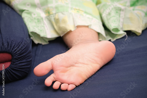 Close up feet of girl sleepy head on bed, Beautiful feet of a woman during treatments. photo