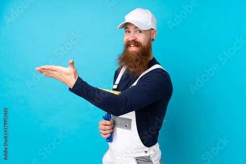 Painter man with long beard over isolated blue background extending hands to the side for inviting to come