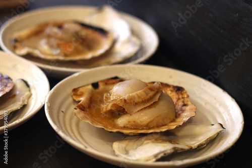 Close up of delicious grilled scallop with its shell on the plate, Hiroshima, Japan