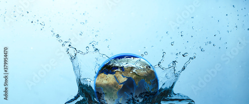 Water splash with Earth on blue background