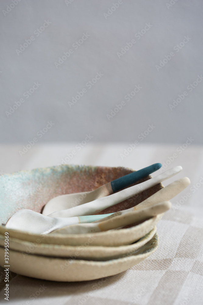 Detail of ceramic table ware with spoons and stacked bowls Detail of ceramic table ware with spoons and stacked bowls