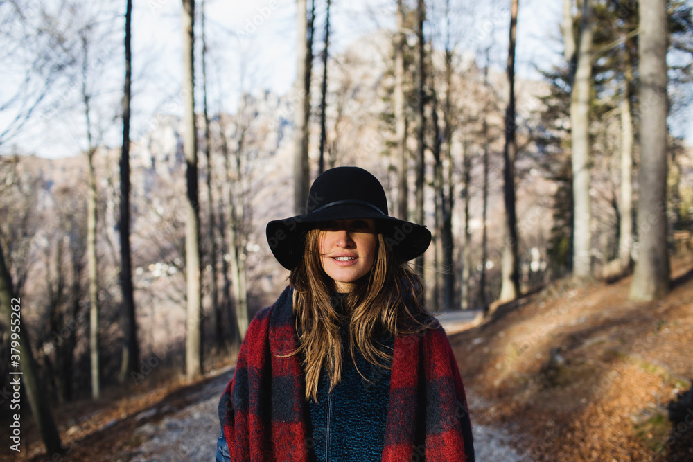 Portrait of woman with hat on a path in the mountains Portrait of woman with hat on a path in the mountains