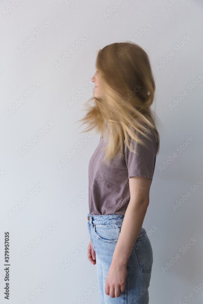 Side view of teen girl with movement and blurred face Side view of teen girl with movement and blurred face