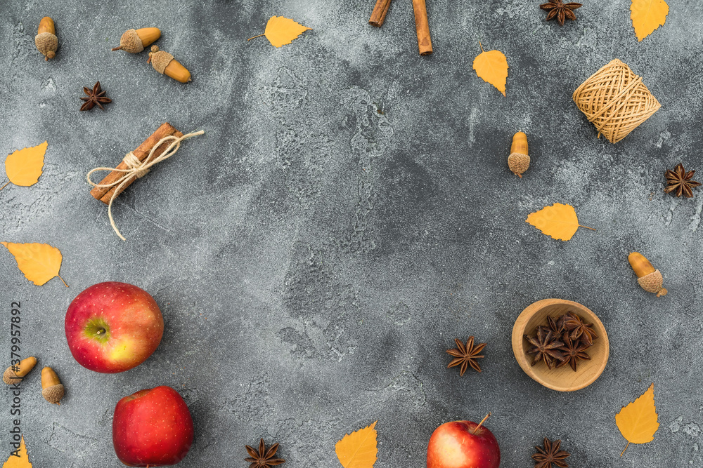 Thanksgiving day frame concept. Fall leaves, apple, cinnamon and acorns on dark. Flat lay