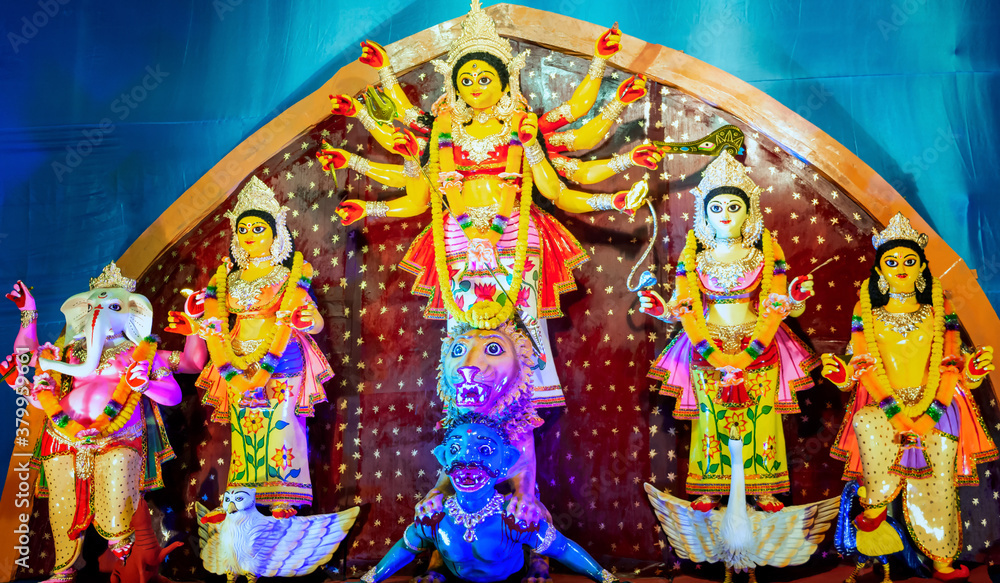 Fototapeta premium Durga Puja or Durgotsava,is an annual Hindu festival celebrated mainly in West Bengal,Indian.Durga is Goddess riding a lion with many arms each carrying weapon and defeating evil power of Mahishasura.