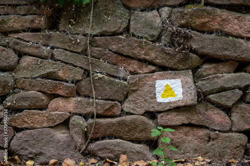 Tourist path sign on a stone wall in Bakony forest in Hungary, Central Europe