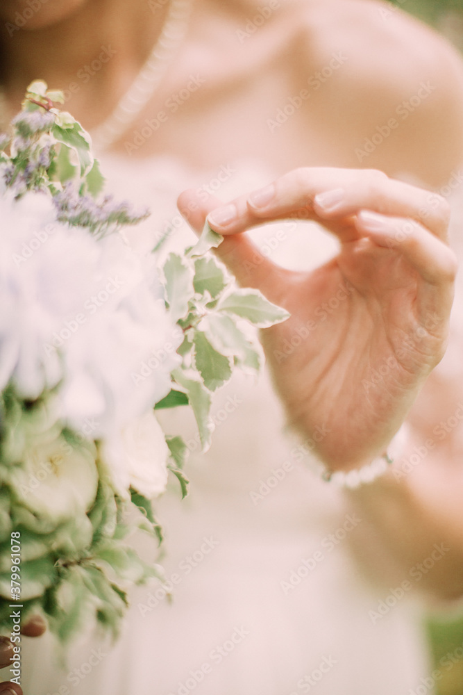 Morning of the bride before the wedding ceremony. Color photo of hands on a wedding dress. Morning of the bride before the wedding ceremony. Color photo of hands on a wedding dress.