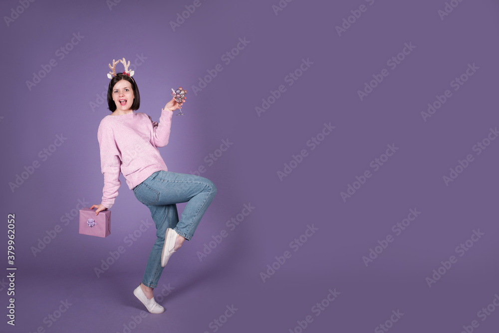 Happy Christmas woman having fun with gift on purple banner background Happy Christmas woman having fun with gift on purple banner background